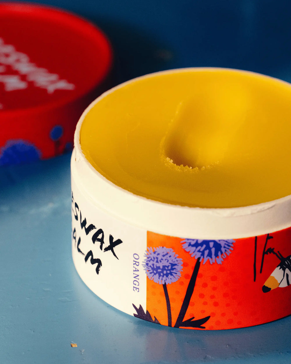 An open-style ointment with orange scent.