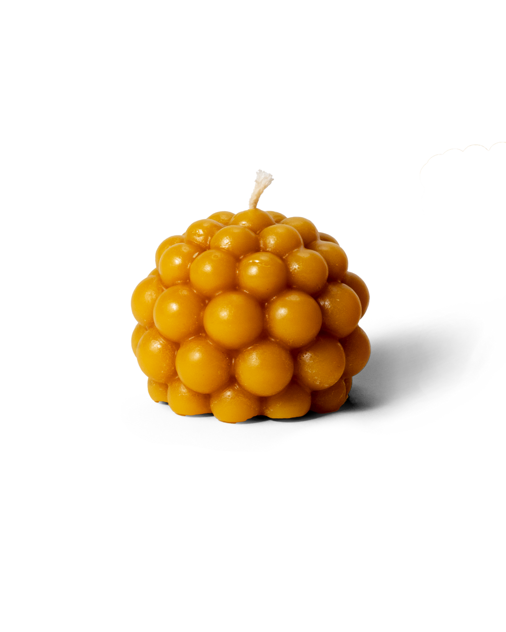 Beeswax candle in the shape of a salmberry, hand-molded from natural beeswax.