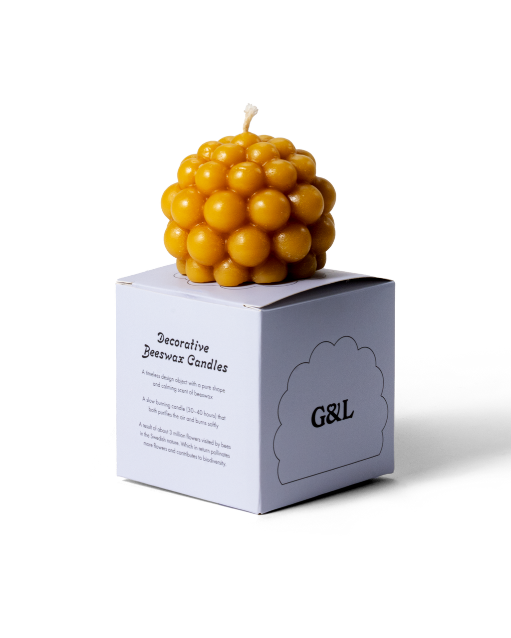 Handmade beeswax candle shaped like a salmberry with a warm, natural color.