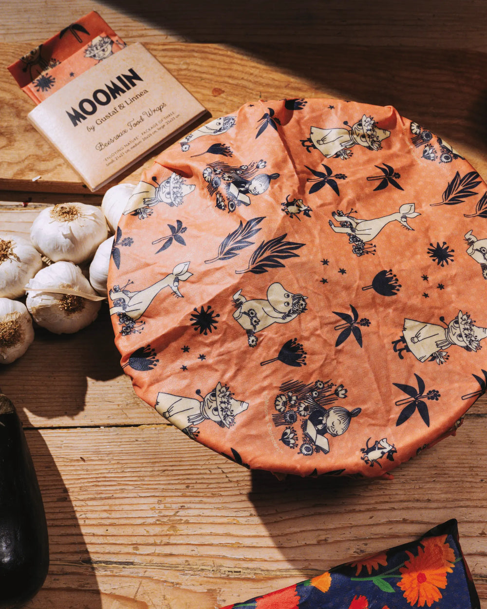 beeswax wrap Moomin motif covering a bowl in a kitchen.