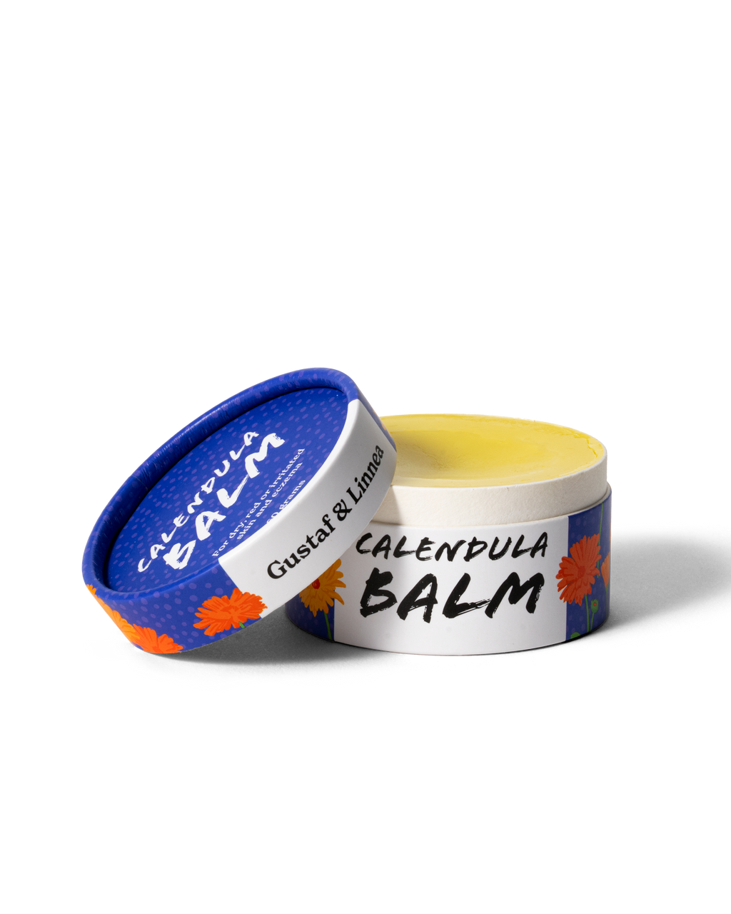 Öppen burk med ringblomssalva som visar den mjuka, gula salvan inuti