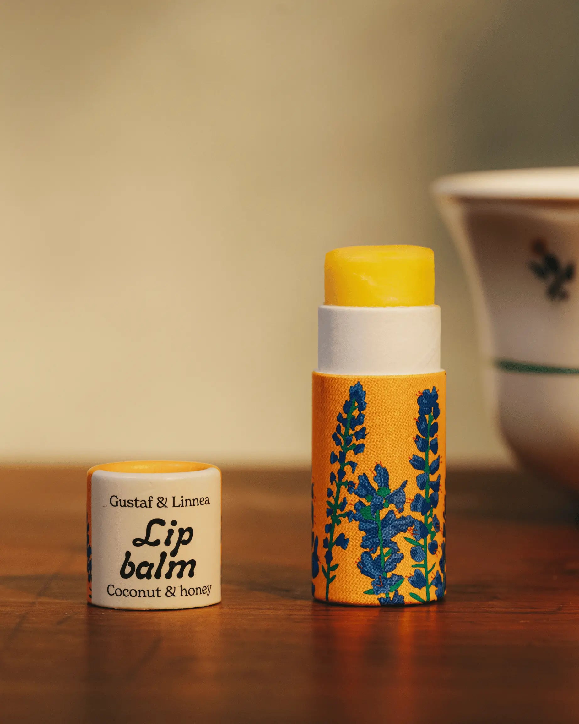 An open lip balm a blueberry motif and coconut flavor.