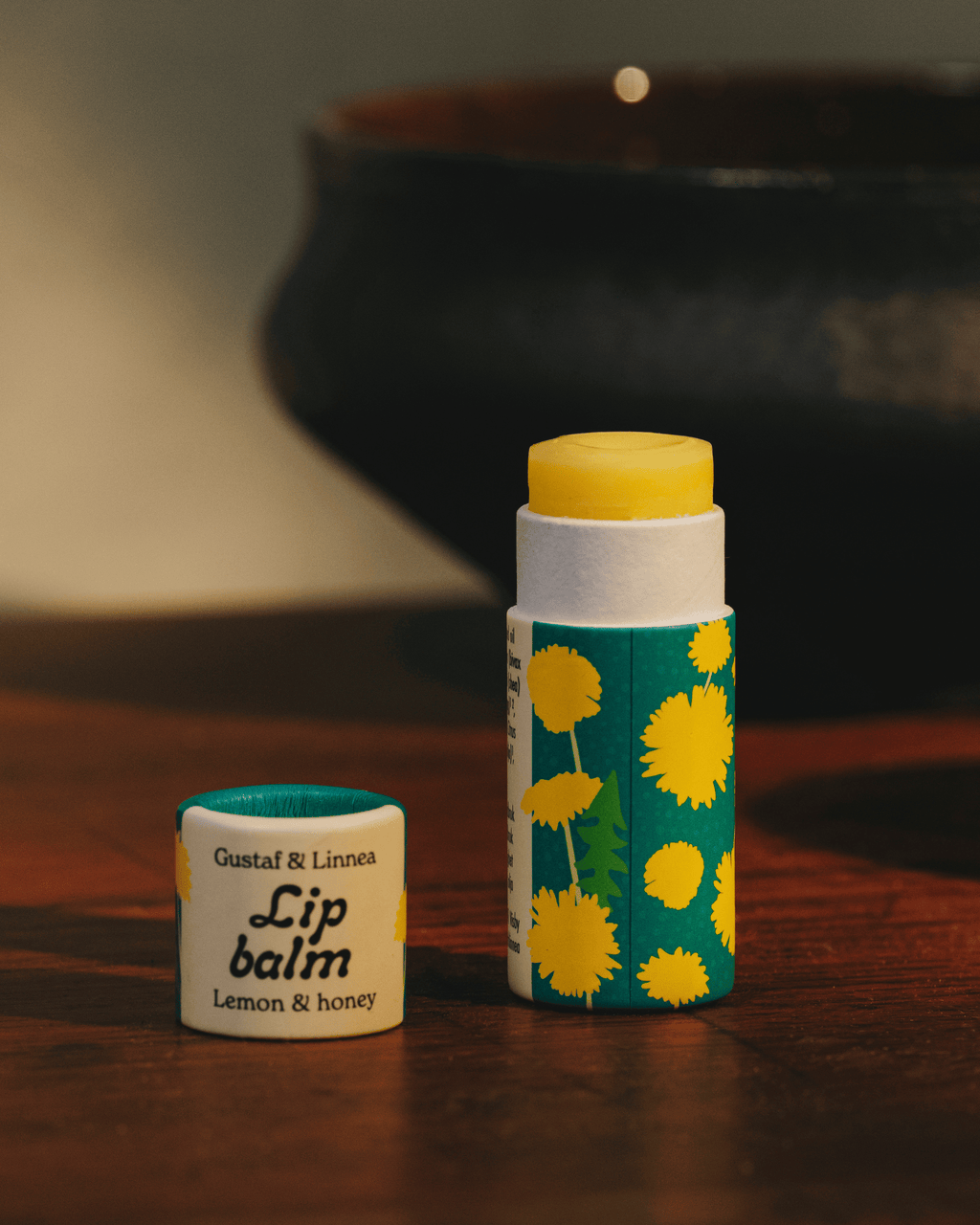 Lip balm dandelion motif and lemon flavor.