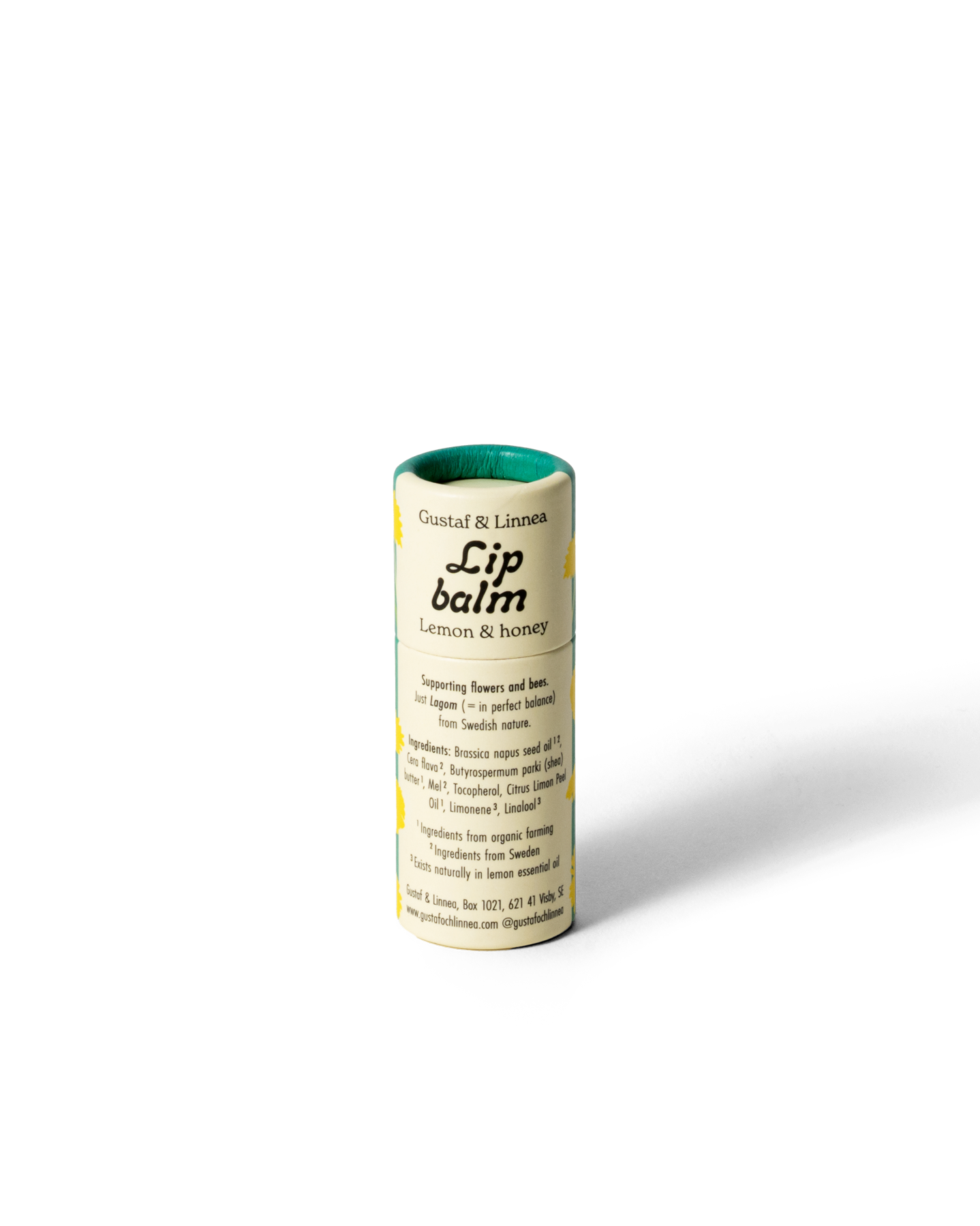 Närbild på handgjort läppcerat med maskrosmotiv i pappförpackning