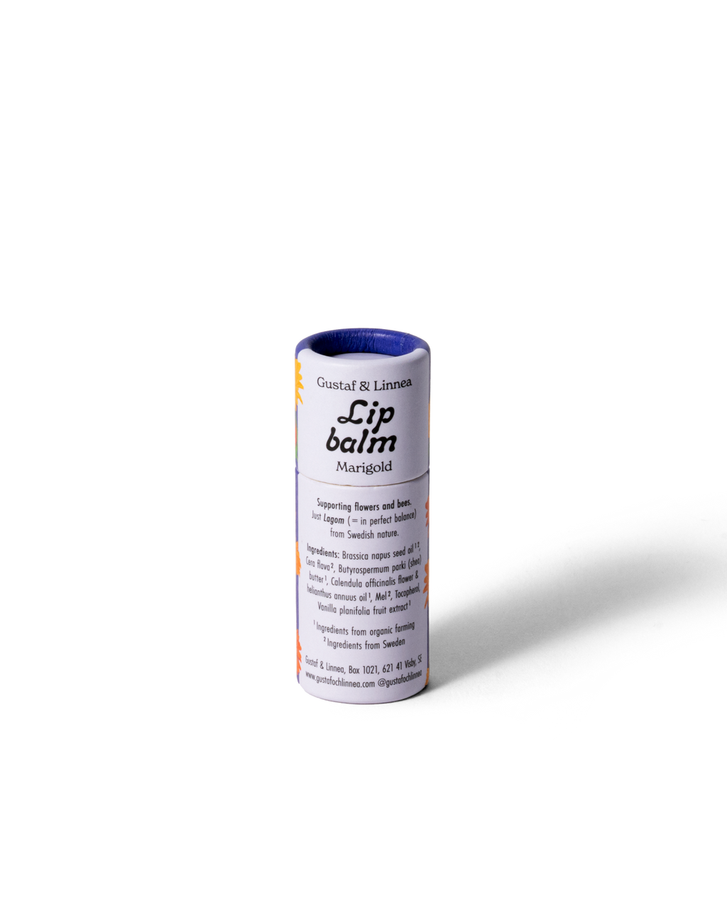 Lip balm calendula, opened cardboard tube with lid next to it.