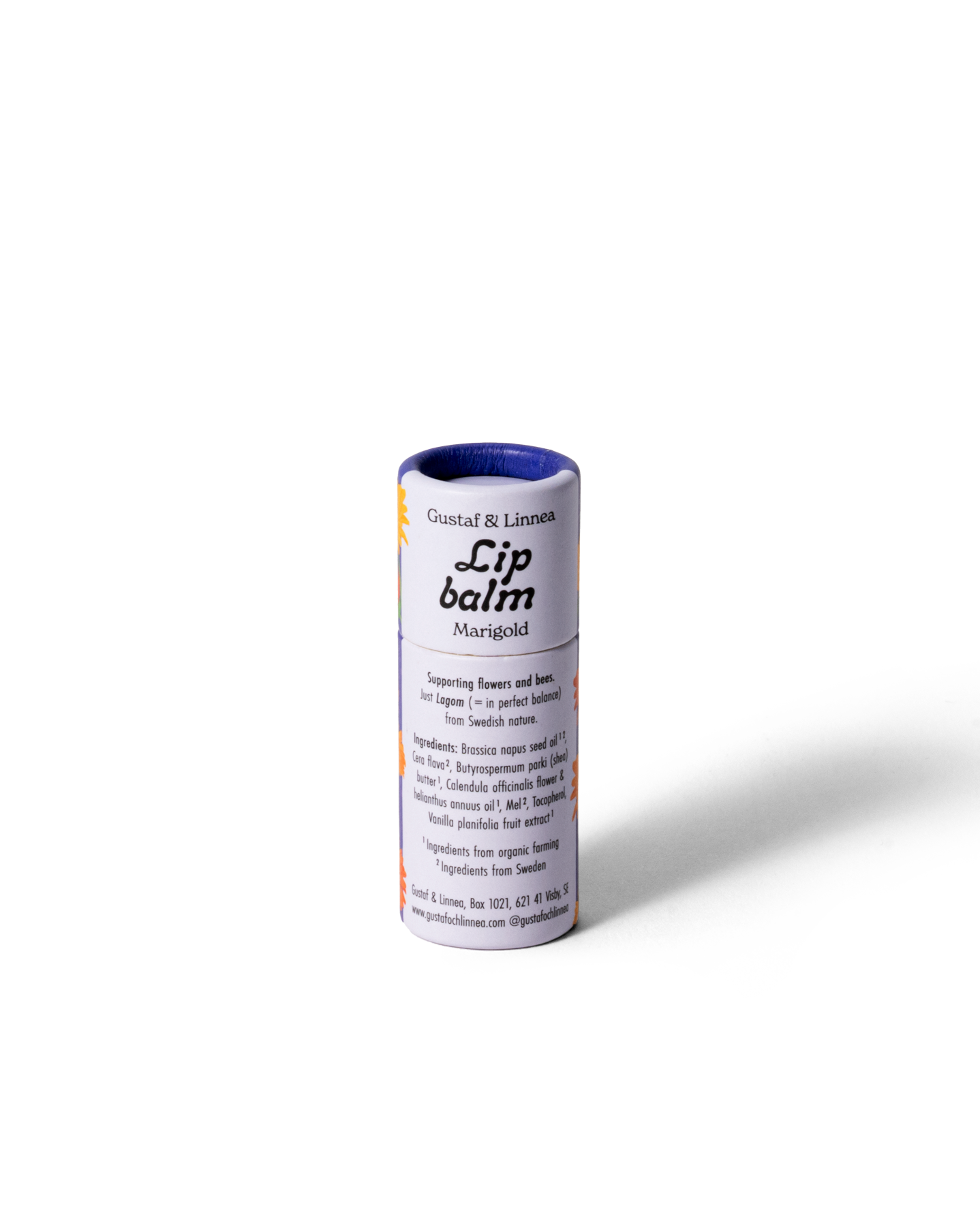 Läppcerat med ringblomma, öppnad papphylsa med lock bredvid.